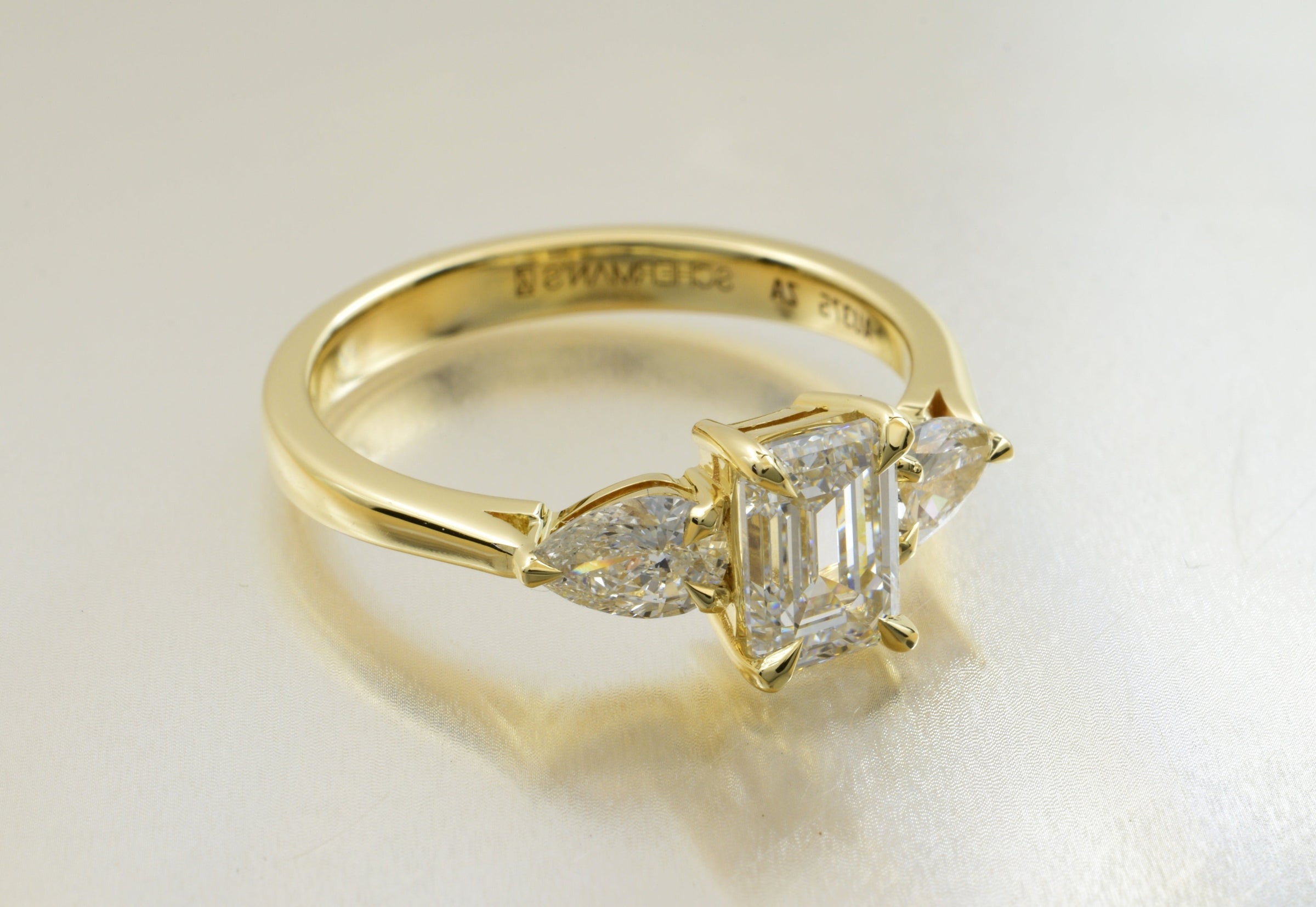 Yellow gold emerald-cut and pear diamond engagement ring made by Scherman's