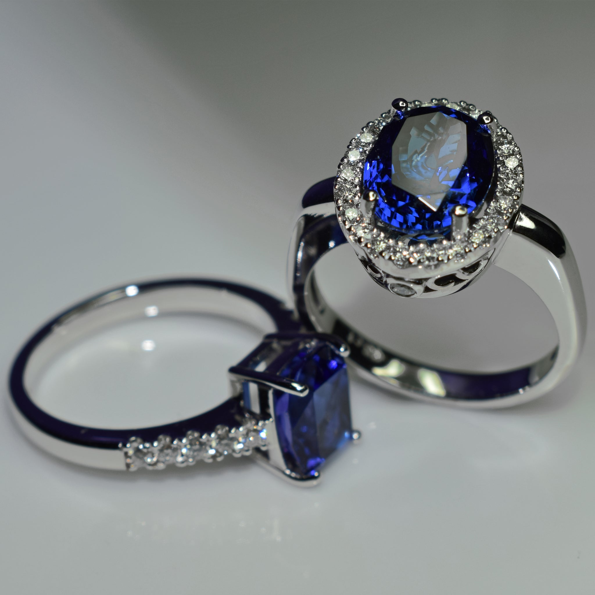 Oval tanzanite halo and cushion solitaire in 18K white gold