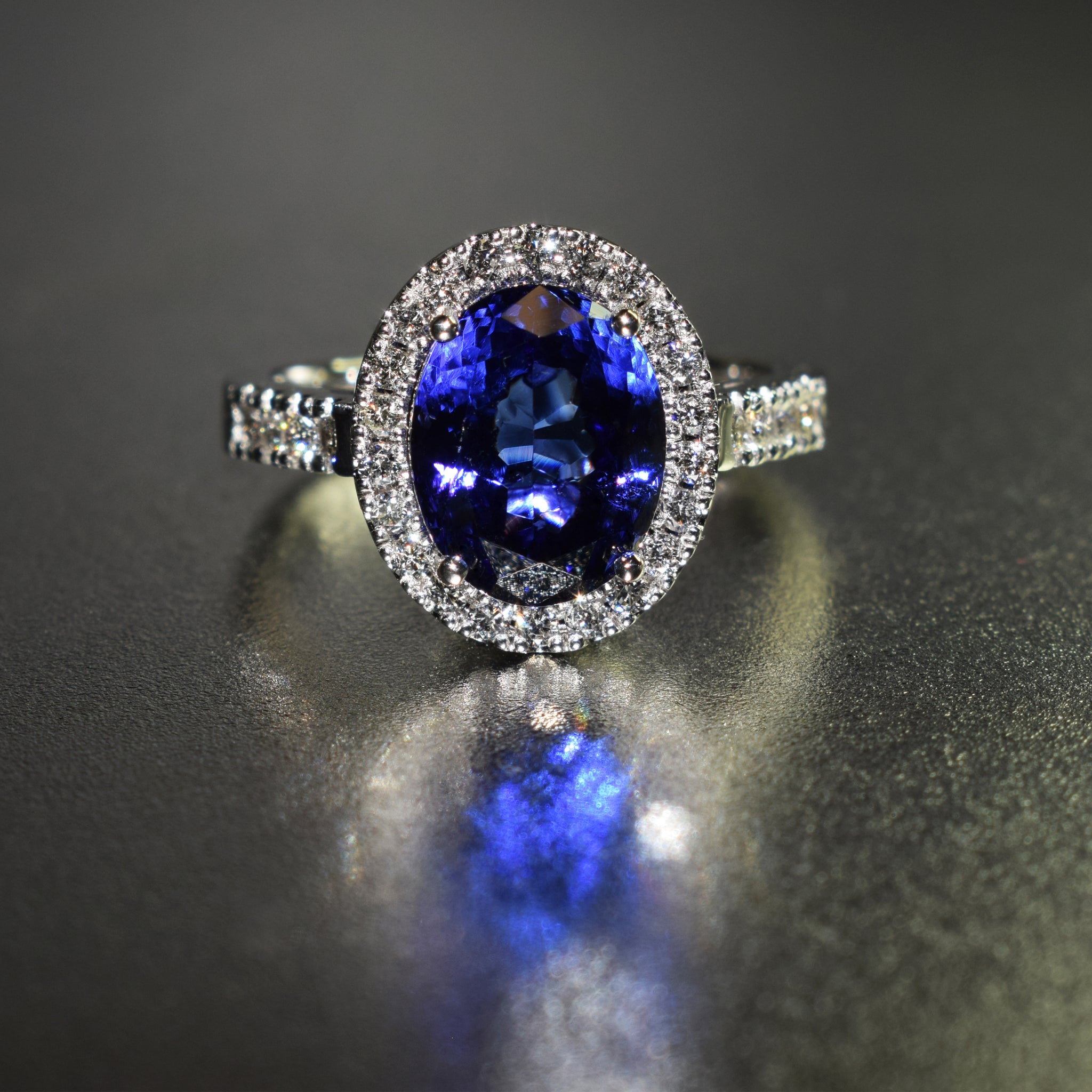 Oval tanzanite with diamond halo in 18K white gold