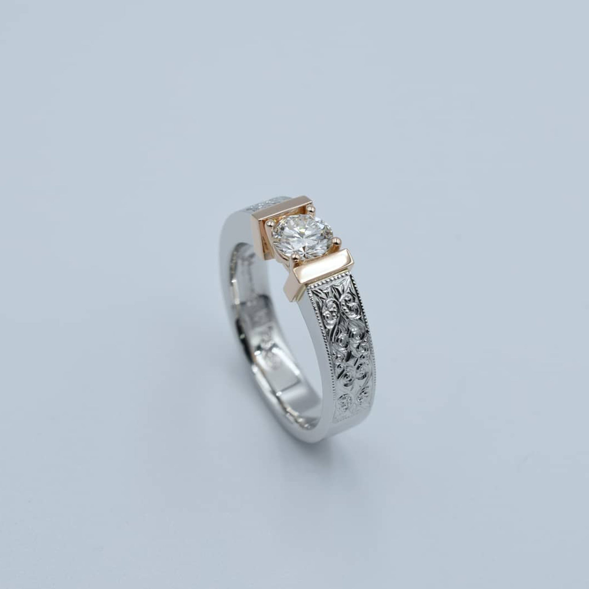 Platinum & 18K rose gold diamond solitaire with fine hand-engraved side detail