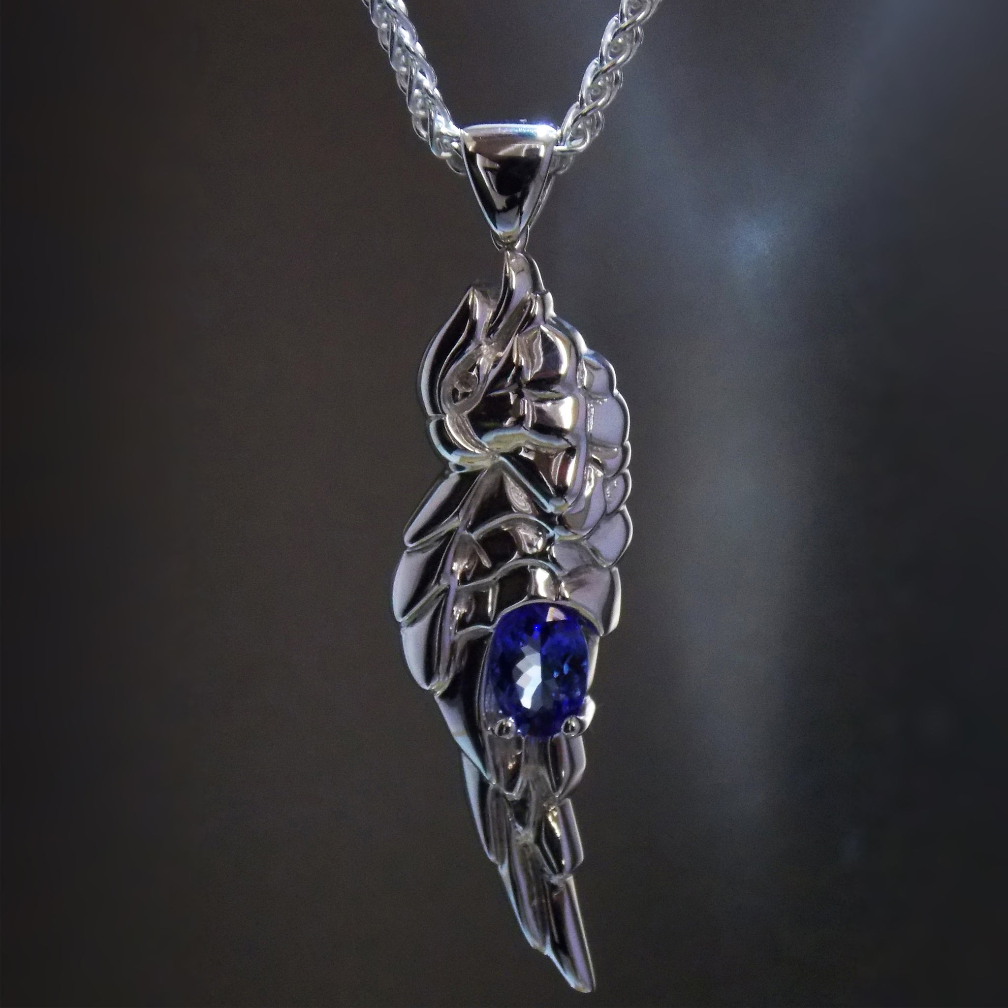 Silver hand carved parrot pendant with oval tanzanite