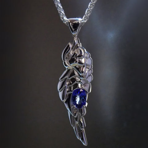 Silver hand carved parrot pendant with oval tanzanite